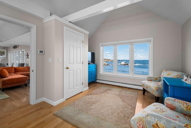 sitting room with light hardwood / wood-style floors, a baseboard radiator, and lofted ceiling