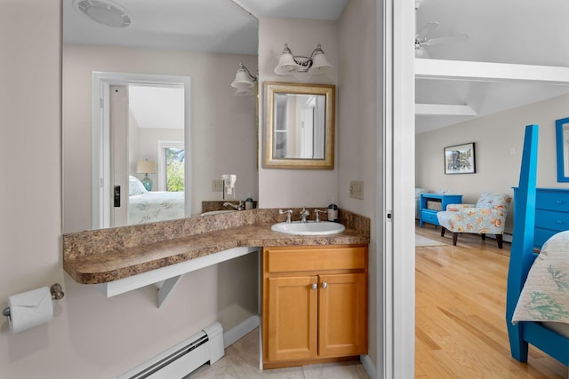 bathroom featuring ceiling fan, a baseboard heating unit, vanity, and wood-type flooring