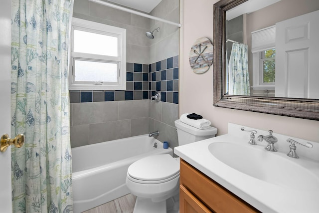 full bathroom with shower / bathtub combination with curtain, hardwood / wood-style flooring, vanity, and toilet