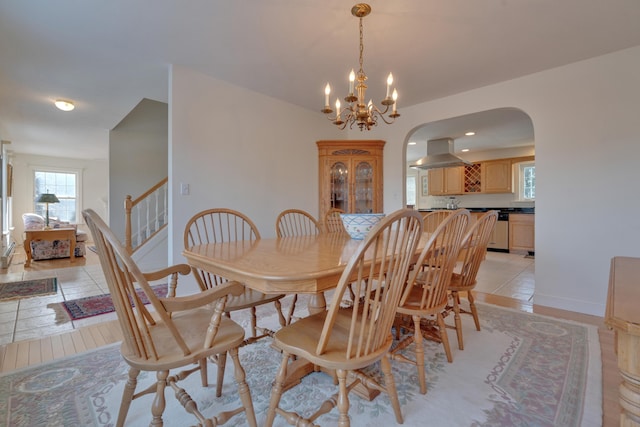 tiled dining room with a notable chandelier