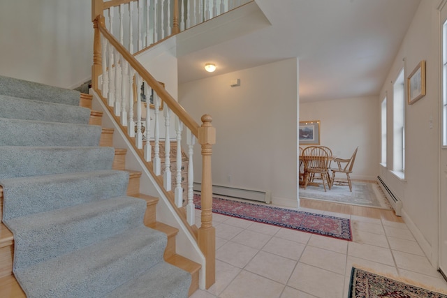 interior space with baseboard heating and light tile patterned floors