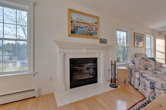 living room featuring hardwood / wood-style flooring and a baseboard heating unit