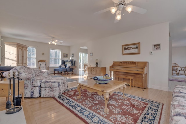 living room with light wood-type flooring and ceiling fan