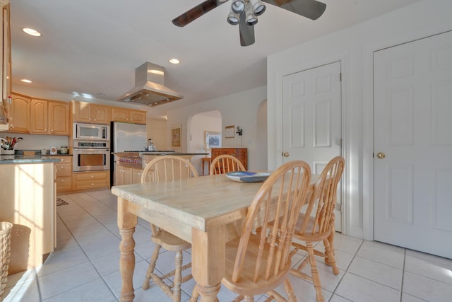 dining area with ceiling fan and light tile patterned floors