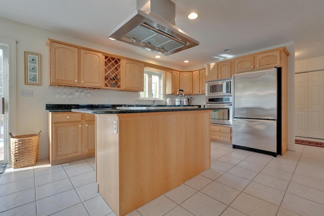 kitchen with light brown cabinets, stainless steel appliances, and a kitchen island