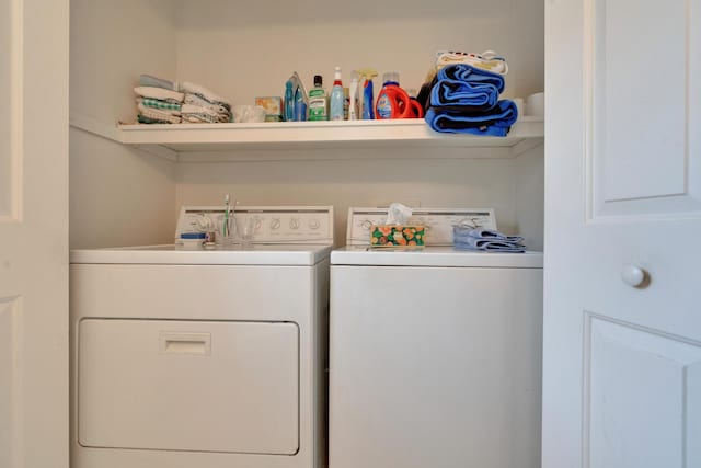 clothes washing area featuring separate washer and dryer