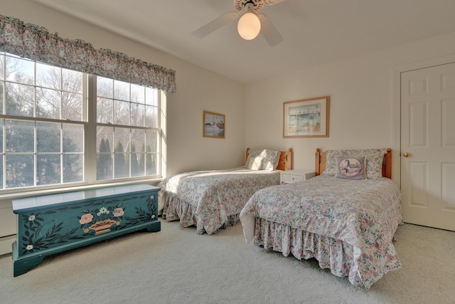 bedroom featuring ceiling fan and carpet