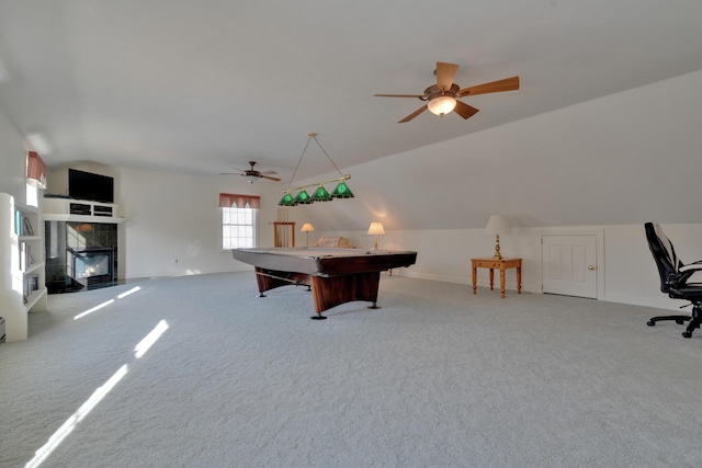 game room with light carpet, billiards, vaulted ceiling, ceiling fan, and a tile fireplace