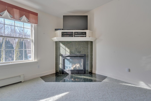 interior details featuring a baseboard radiator and a tile fireplace