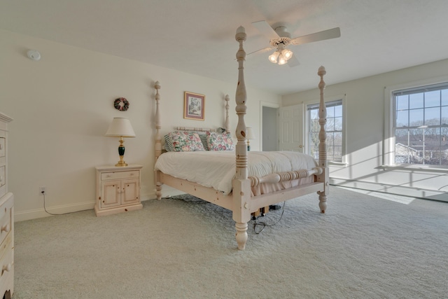 bedroom featuring ceiling fan and light carpet