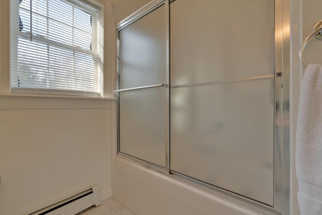 bathroom featuring tile patterned flooring, bath / shower combo with glass door, and baseboard heating