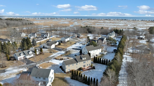 snowy aerial view featuring a water view