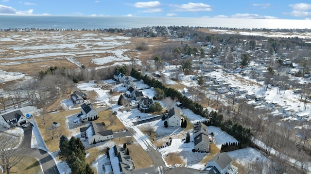 snowy aerial view featuring a water view