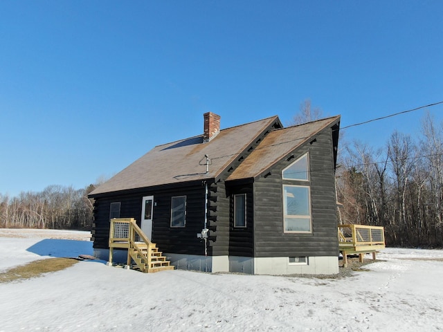 view of snow covered rear of property