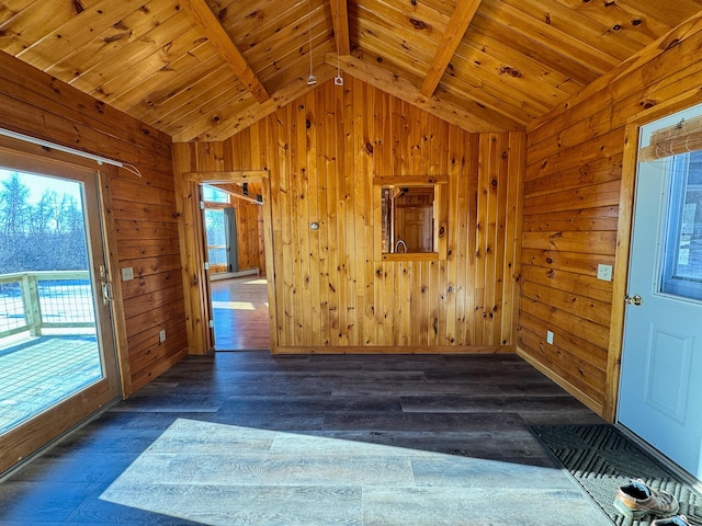 foyer with lofted ceiling with beams, dark wood-type flooring, wooden walls, and wooden ceiling