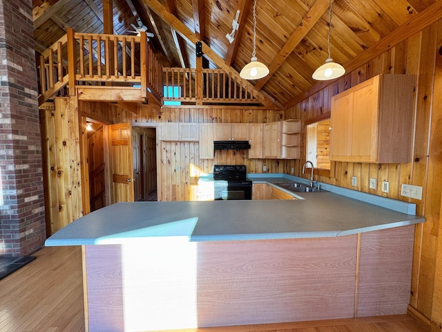 kitchen with kitchen peninsula, light brown cabinetry, black electric range, and sink