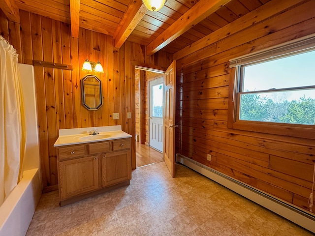 bathroom with a healthy amount of sunlight, a baseboard heating unit, beamed ceiling, and wood walls