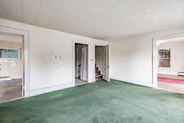 spare room featuring baseboard heating and carpet flooring