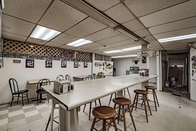 kitchen featuring a kitchen breakfast bar and a drop ceiling