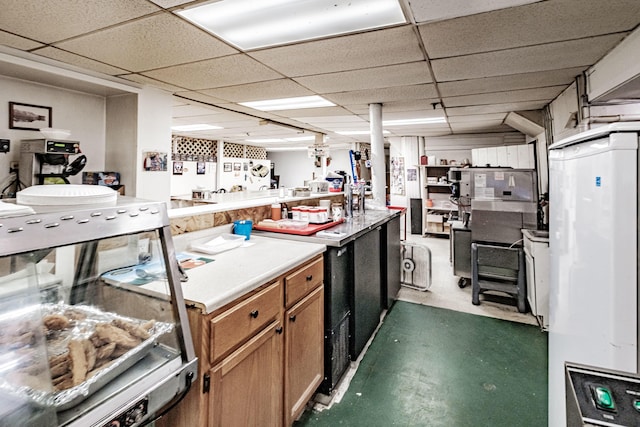 kitchen featuring a drop ceiling and kitchen peninsula