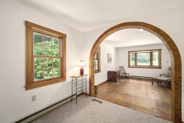 sitting room with wood-type flooring and baseboard heating