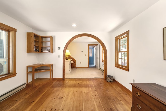 hallway featuring baseboard heating and light wood-type flooring