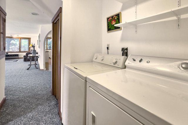 washroom featuring washer and dryer and dark carpet