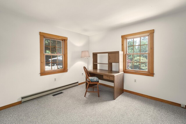 office with a baseboard heating unit and carpet