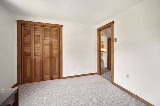 unfurnished bedroom featuring light carpet