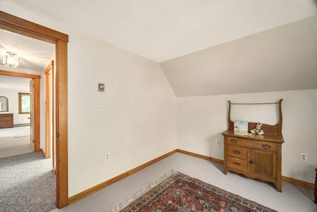 bonus room featuring light carpet and vaulted ceiling