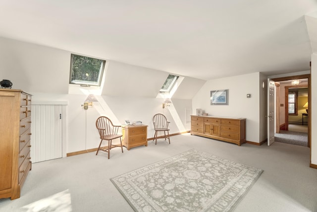 living area with light colored carpet and vaulted ceiling