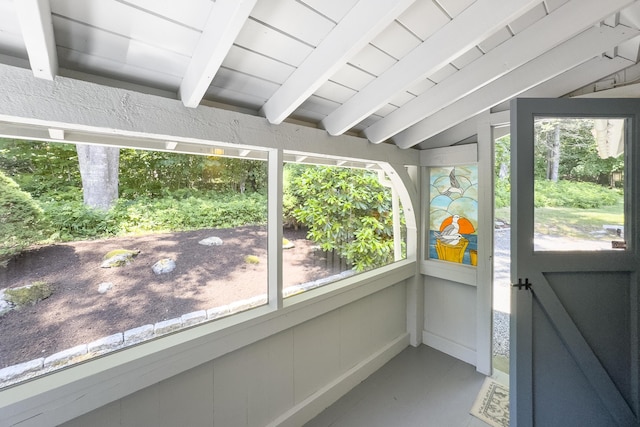 unfurnished sunroom with lofted ceiling with beams and wood ceiling