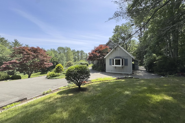 view of outbuilding featuring a lawn