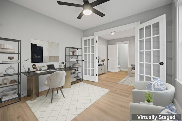 home office with wood-type flooring, ceiling fan, and french doors