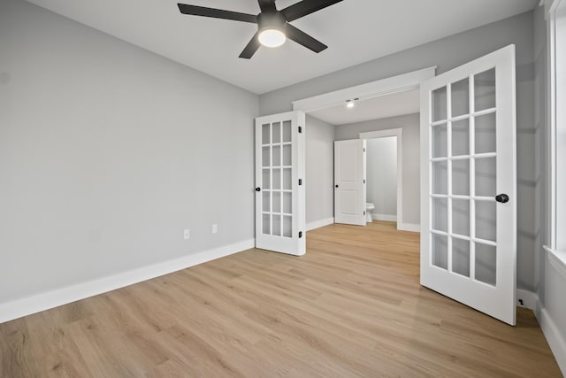 spare room with light wood-type flooring, ceiling fan, and french doors