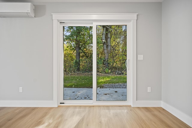 entryway featuring an AC wall unit and light hardwood / wood-style floors