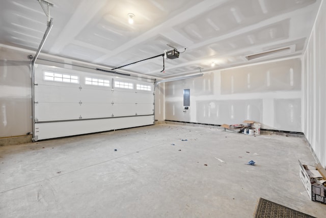 garage with electric panel and a garage door opener