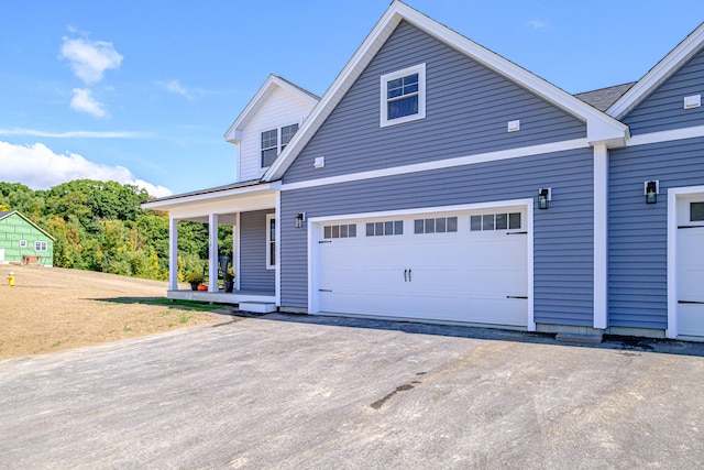 view of property featuring covered porch and a garage