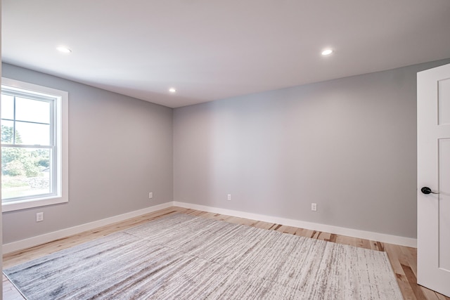 unfurnished room with light wood-type flooring