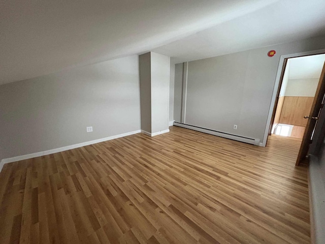 bonus room featuring baseboard heating and light hardwood / wood-style flooring