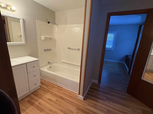 bathroom featuring tub / shower combination, hardwood / wood-style floors, and vanity