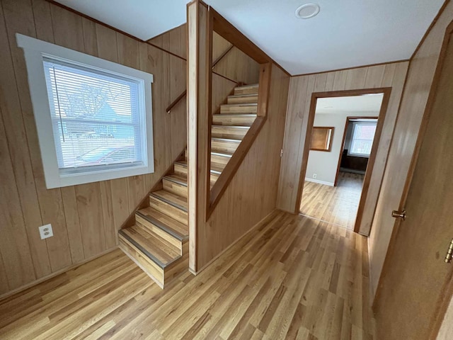 staircase featuring hardwood / wood-style flooring and wood walls