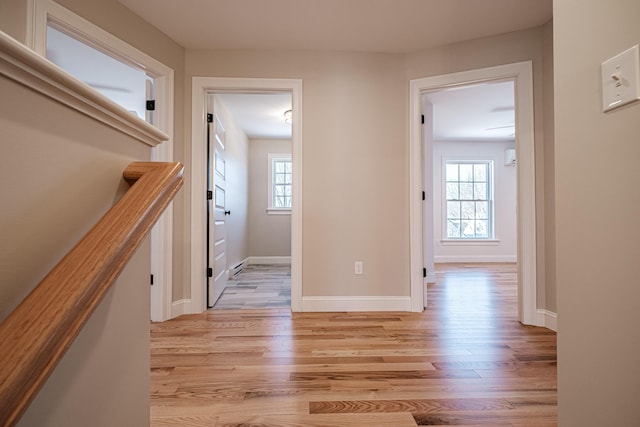 corridor with light hardwood / wood-style floors