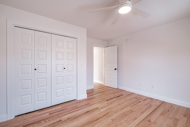 unfurnished bedroom with ceiling fan, a closet, and light hardwood / wood-style floors