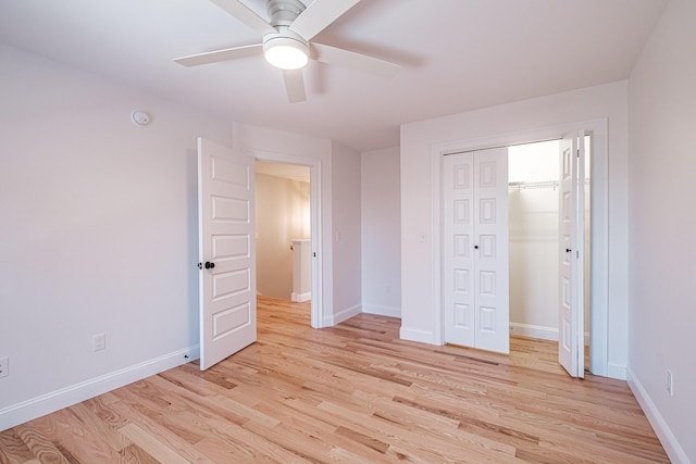 unfurnished bedroom with ceiling fan, light hardwood / wood-style floors, and a closet