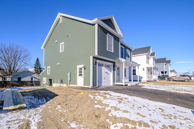 snow covered property featuring a garage