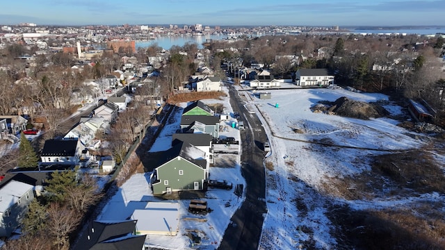 snowy aerial view with a water view