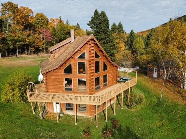 55 Brown Rd, Oakfield, ME 04763 - back of property featuring a wooden deck and a lawn
