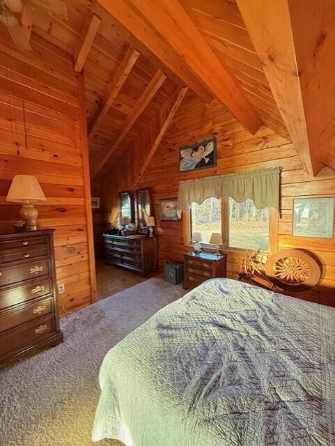 55 Brown Rd, Oakfield, ME 04763 - carpeted bedroom with wood ceiling, wooden walls, and lofted ceiling with beams