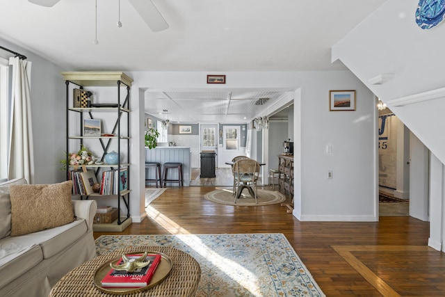 living room featuring dark hardwood / wood-style flooring and ceiling fan